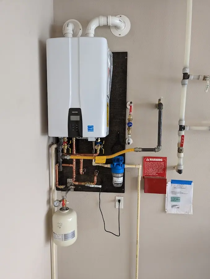 Professional plumber installing copper piping in a McKenzie home